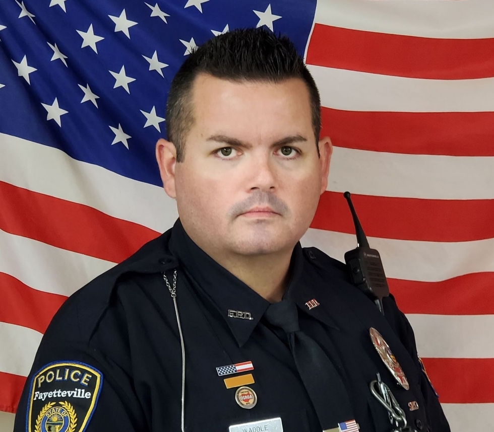 Officer Waddle with American flag in background
