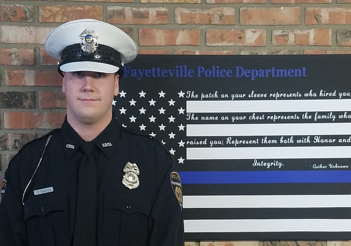 resource officer in front of flag